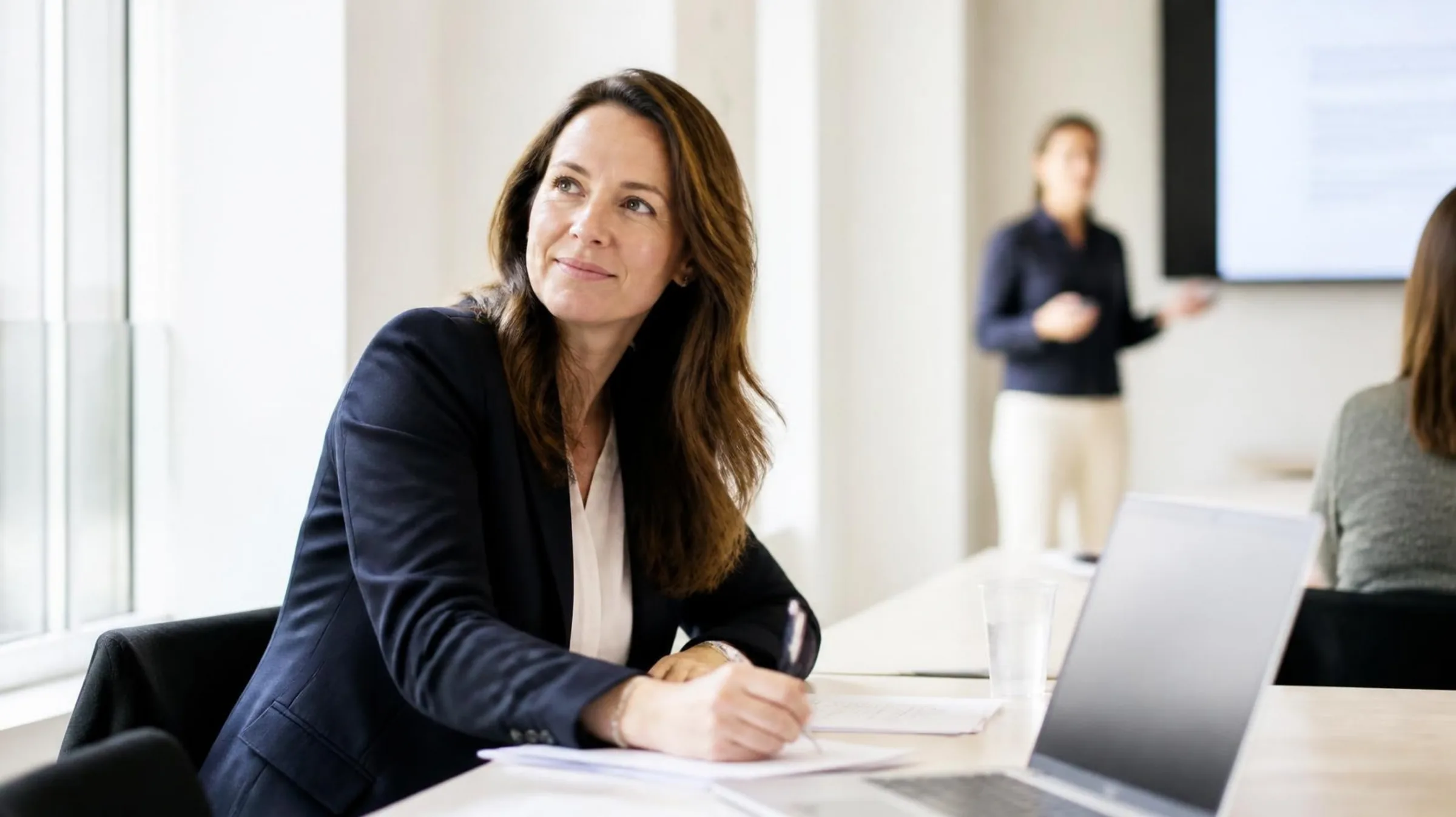 A lawyer takes notes on a handout during a training session